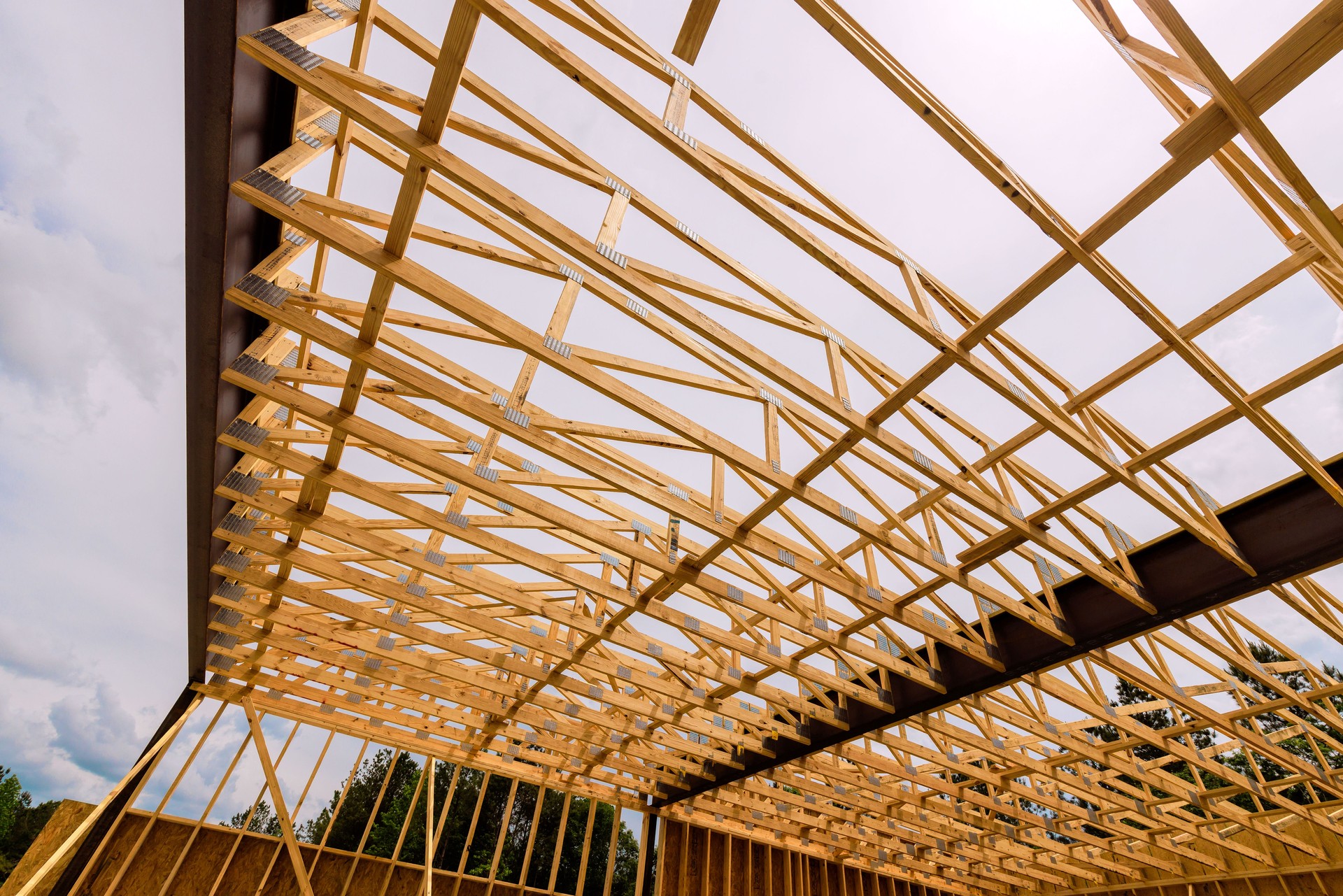 Wooden framework of building under construction in suburban area shows intricate design craftsmanship